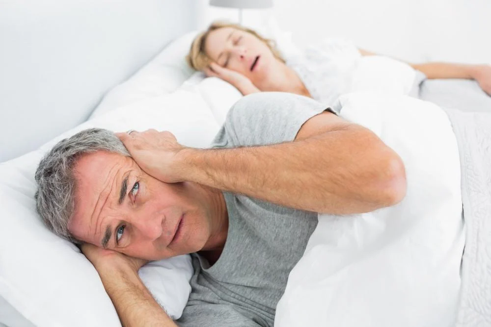 man unable to sleep wife snoring